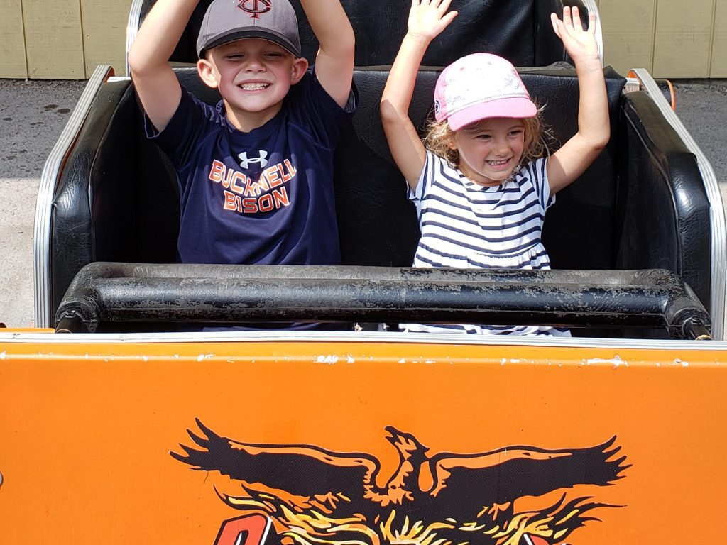 young kids on the Phoenix roller coaster at Knoebels