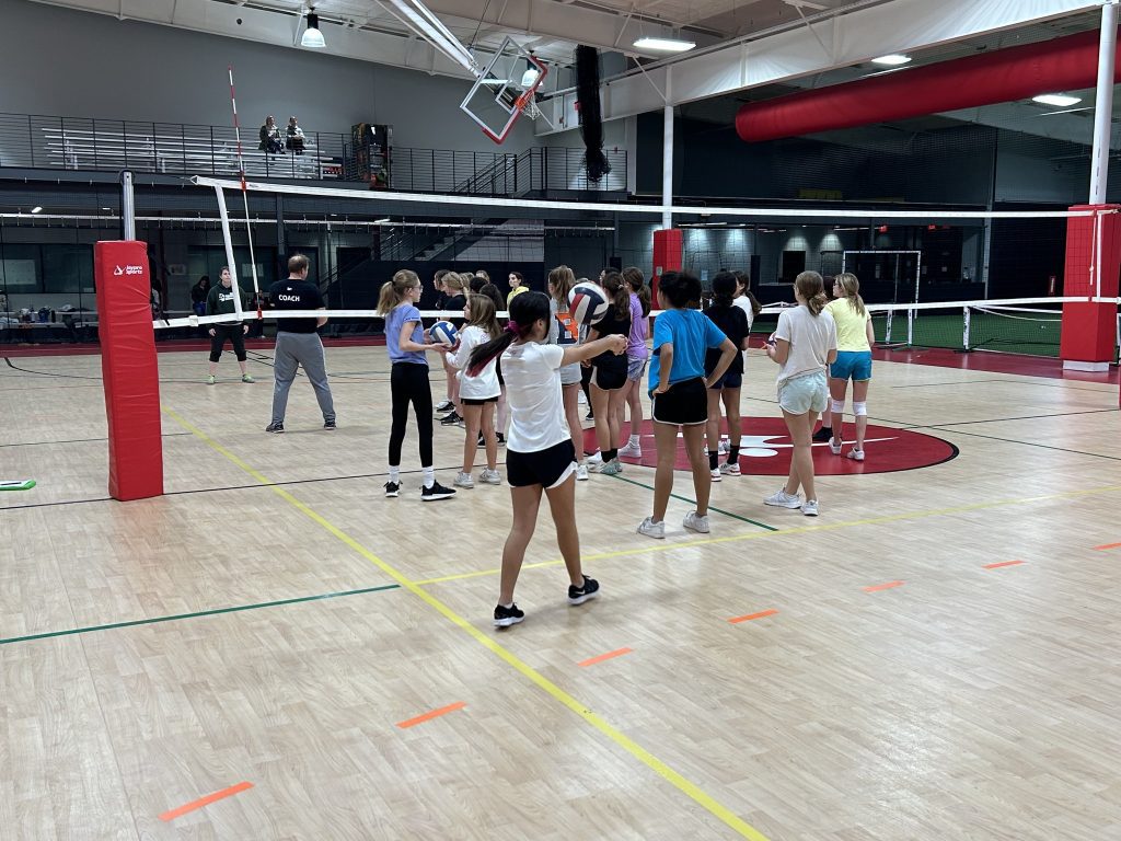 volleyball club photo of kids and coach