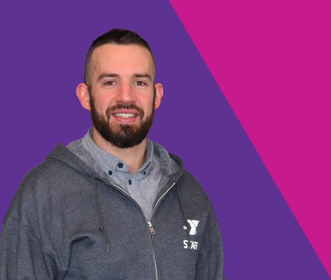 Headshop of personal trainer Josh Sorber on a purple and pink background.